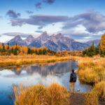 A hiker admires the view of the Snake River and Grand Teton National Park, Wyoming.